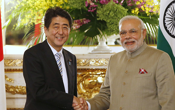 India's Prime Minister Narendra Modi, right, and Japan's Prime Minister Shinzo Abe shake hands before their talks at the state guest house in Tokyo Monday, Sept. 1, 2014. (AP Photo/Toru Hanai, Pool)